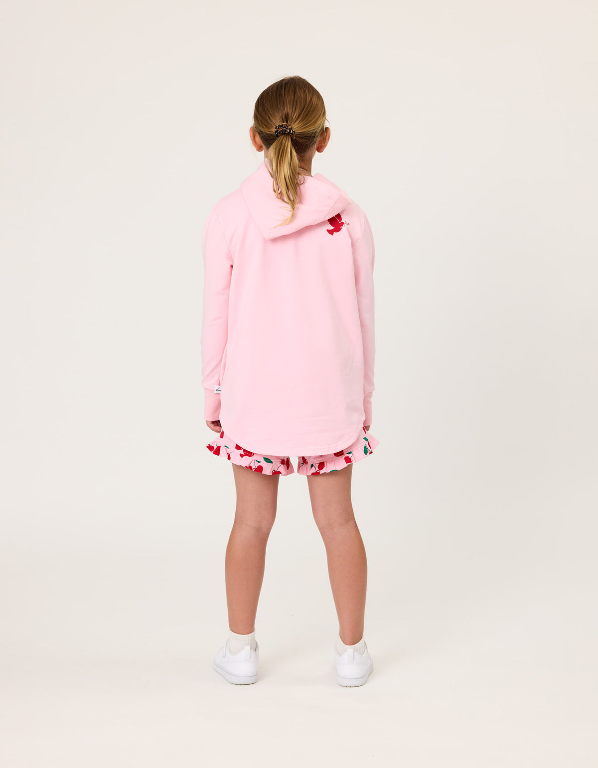 Girl wearing a pink outfit with a white background