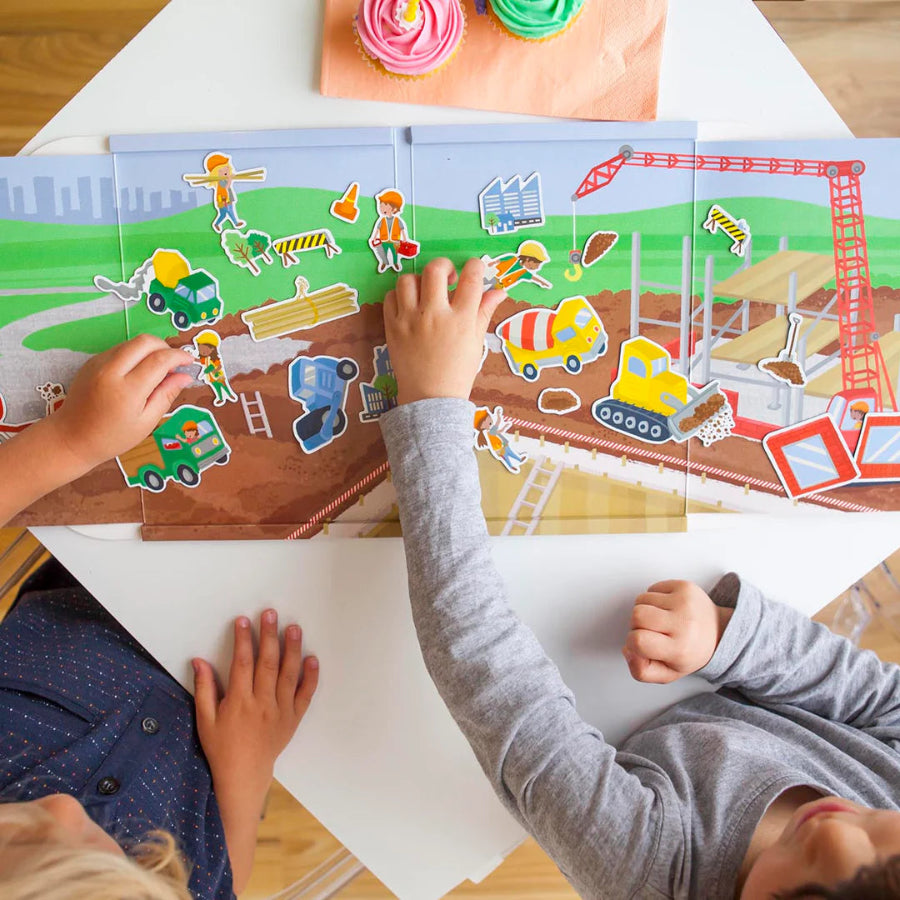 Children playing with a construction-themed puzzle on a table.