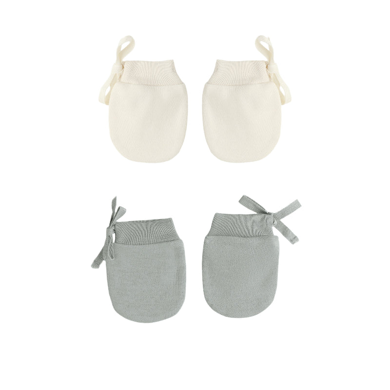 Two pairs of baby mittens, one cream and one gray, on a white background.