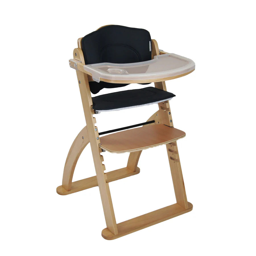 Wooden high chair with black cushion on a white background