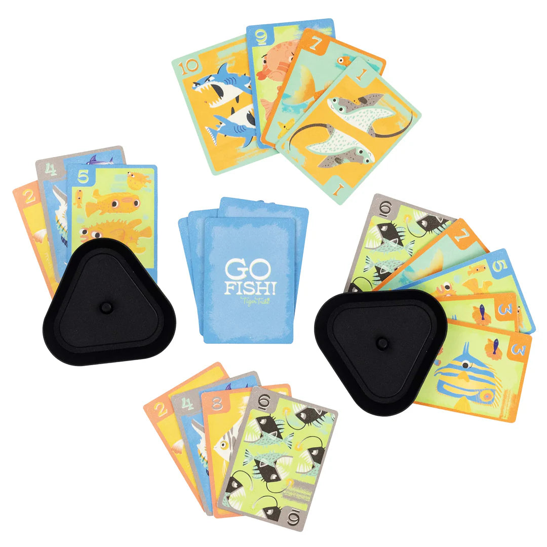 Collection of children's fishing card game with colorful cards and black containers on a white background