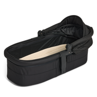 Black baby bassinet with beige interior on a white background