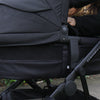 Black stroller with a child sitting inside, brand 'Edwards & Co' visible