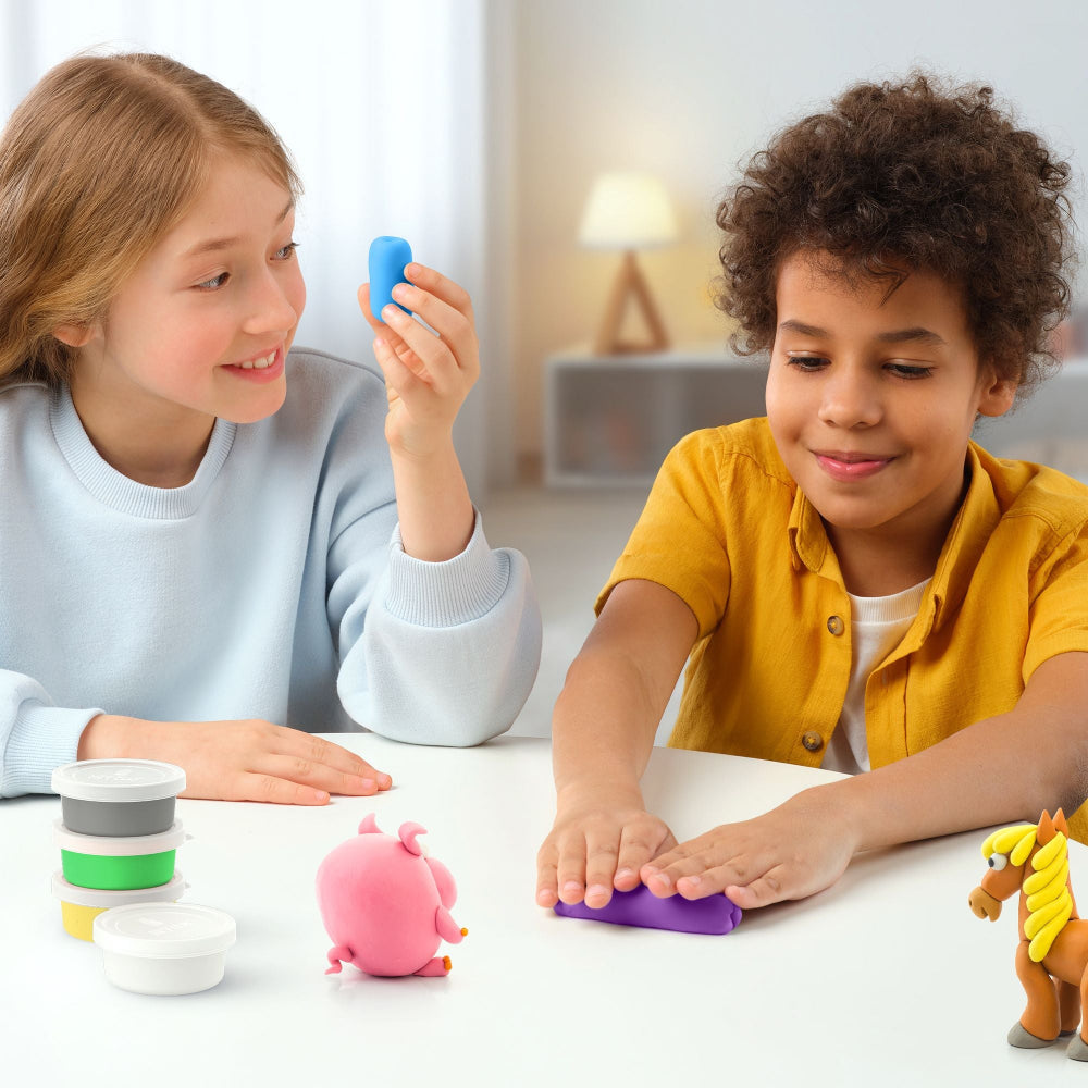 Two children playing with colorful play dough toys on a table.