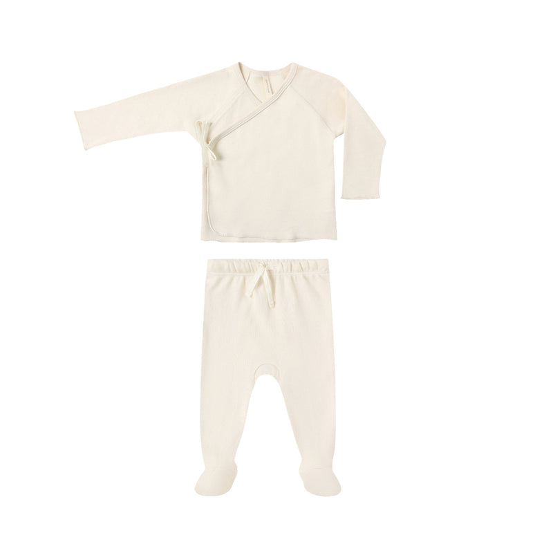 Baby outfit with long-sleeve top and footed pants on a white background