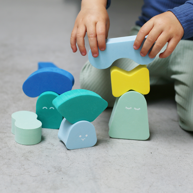 Toddler playing with stacking blocks