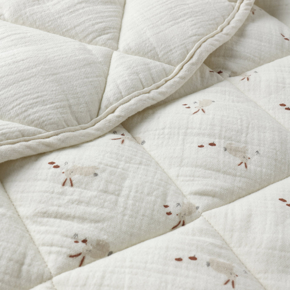 Close-up of a textured white fabric with small bunny patterns