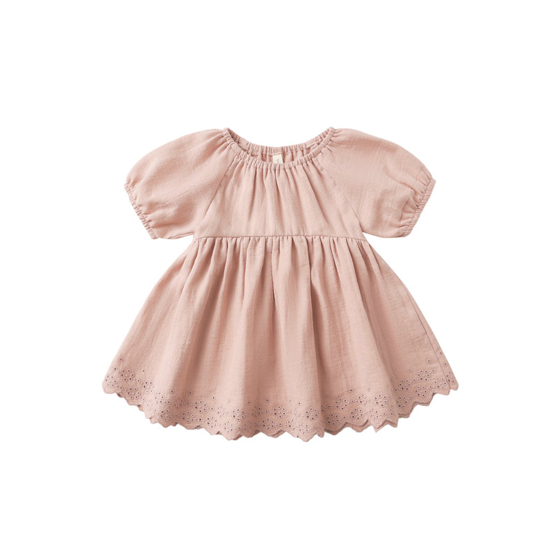 Pink dress with lace details on a white background