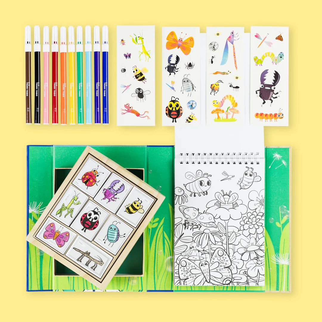 Coloring book with stickers and pencils on a yellow background