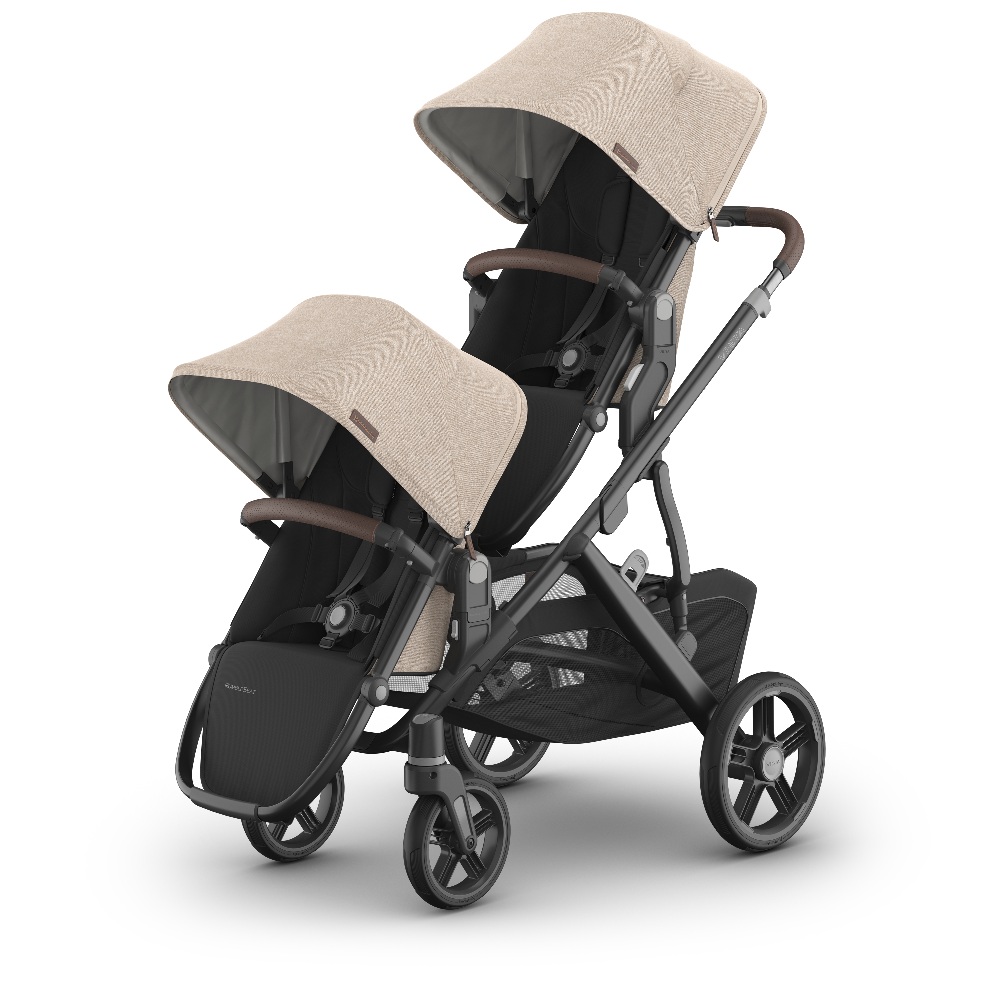 Baby stroller with beige canopy and black seat on a white background