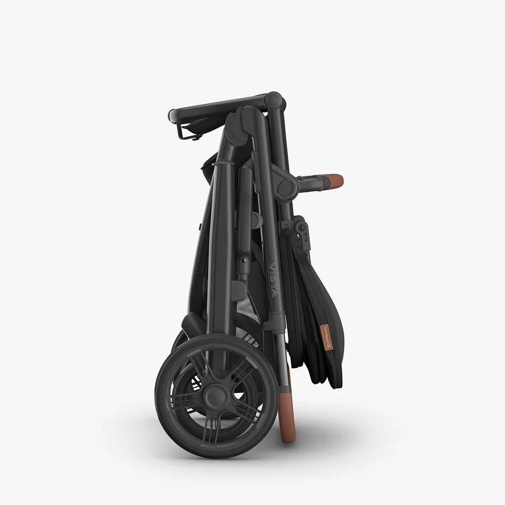 Folded black stroller on a white background